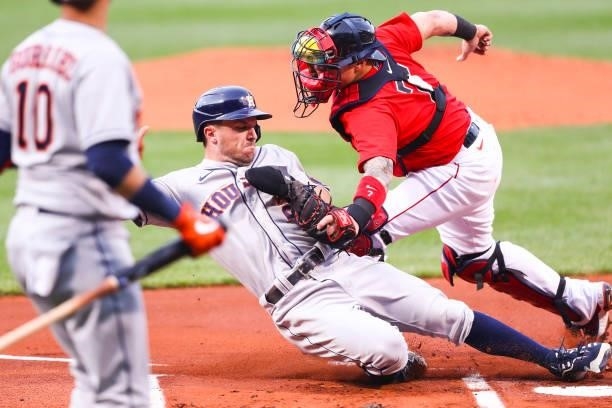 Alex Bregman of the Houston Astros is tagged out at some plate by Christian Vazquez of the Boston Red Sox in the first inning of a game at Fenway...