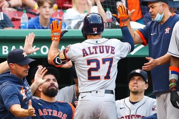 Jose Altuve of the Houston Astros returns to the dugout after scoring in the third inning of a game against the Boston Red Sox at Fenway Park on June...