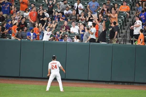 Stewart of the Baltimore Orioles watches a three-run home run by Kevin Pillar of the New York Mets in the third inning during a game at Oriole Park...