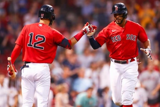 Xander Bogaerts high fives Marwin Gonzalez of the Boston Red Sox after hitting a solo home run I the fourth inning of a game against the Houston...