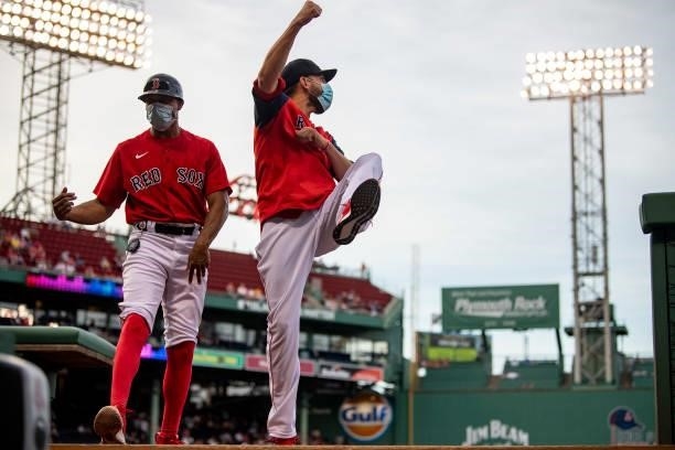 First base coach Tom Goodwin and Matt Barnes of the Boston Red Sox dance before a game against the Houston Astros on June 9, 2021 at Fenway Park in...