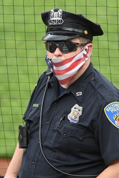 Baltimore City police officer looks on before a game between the New York Mets and Baltimore Orioles at Oriole Park at Camden Yards on June 9, 2021...