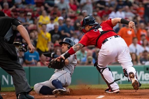 Christian Vazquez of the Boston Red Sox tags out Alex Bregman of the Houston Astros during the first inning of a game on June 9, 2021 at Fenway Park...