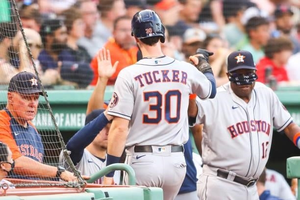 Kyle Tucker of the Houston Astros returns to the dugout after scoring in the second inning of a game against the Boston Red Sox at Fenway Park on...