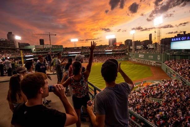 Fans cheer as the sun sets during a game between the Boston Red Sox and the Houston Astros on June 9, 2021 at Fenway Park in Boston, Massachusetts.