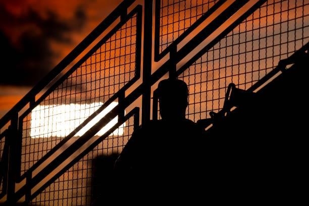 Fan looks on as the sun sets during a game between the Boston Red Sox and the Houston Astros on June 9, 2021 at Fenway Park in Boston, Massachusetts.