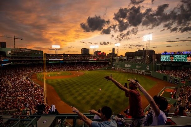 Fans cheer as the sun sets during a game between the Boston Red Sox and the Houston Astros on June 9, 2021 at Fenway Park in Boston, Massachusetts.