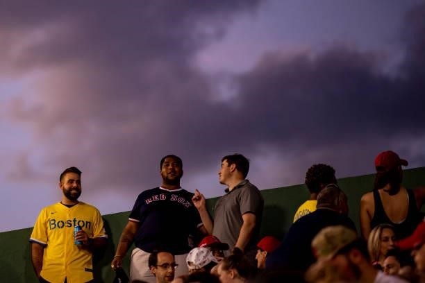 Fans look on as the sun sets during a game between the Boston Red Sox and the Houston Astros on June 9, 2021 at Fenway Park in Boston, Massachusetts.
