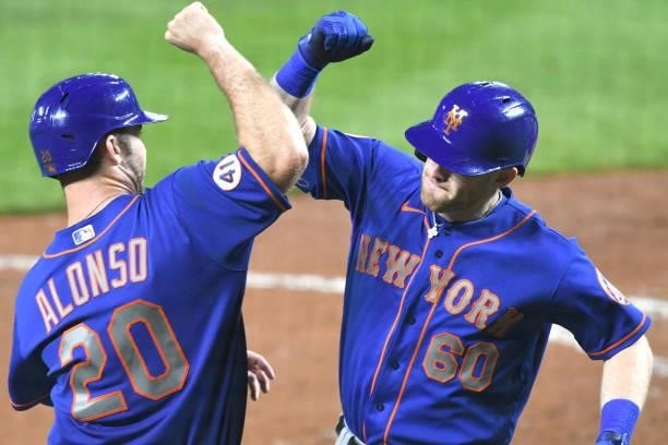Billy McKinney of the New York Mets celebrates a three-run home run during the ninth inning of a game against the Baltimore Orioles at Oriole Park at...