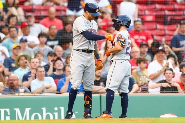 Jose Altuve of the Houston Astros reacts with Carlos Correa of the Houston Astros after hitting a solo home run in the third inning of a game against...