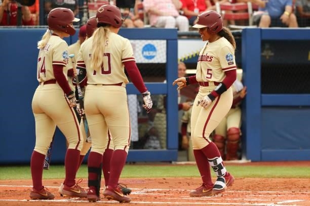 Elizabeth Mason of the Florida St. Seminoles reacts to her two-run home run against the Oklahoma Sooners during the Division I Women's Softball...
