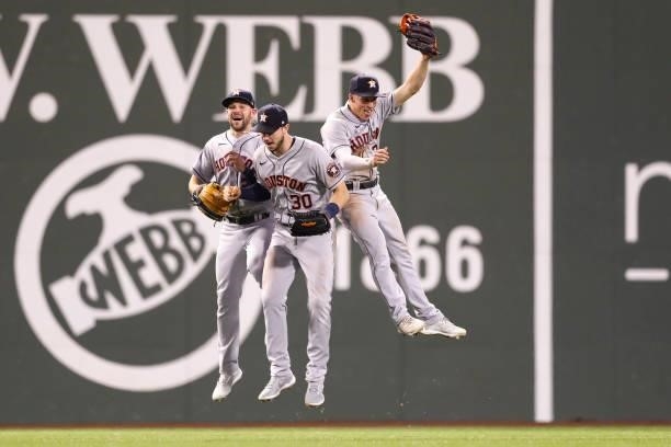 Chas McCormick, Kyle Tucker, and Myles Straw of the Houston Astros celebrate after a win over the Boston Red Sox at Fenway Park on June 9, 2021 in...