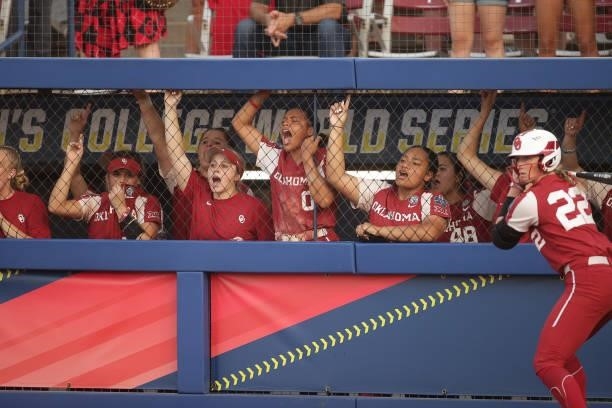 The Oklahoma Sooners celebrate a home run from the dugout during the Division I Women's Softball Championship held at ASA Hall of Fame Stadium on...