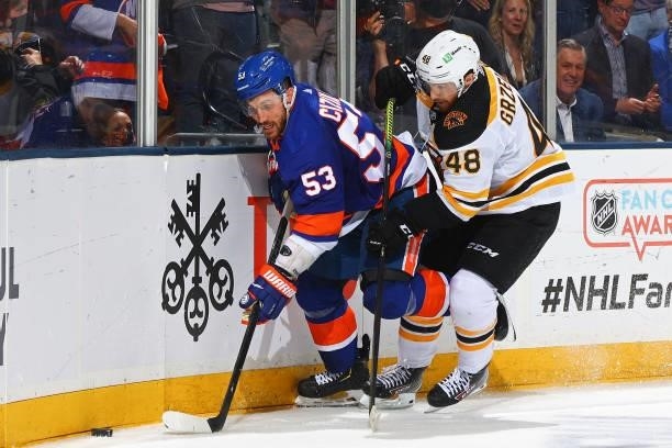Casey Cizikas of the New York Islanders is defended by Matt Grzelcyk of the Boston Bruins during the third period in Game Six of the Second Round of...