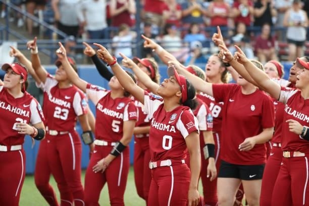 Rylie Boone of the Oklahoma Sooners and her teammates cheer with the crowd during the Division I Women's Softball Championship against the Florida...
