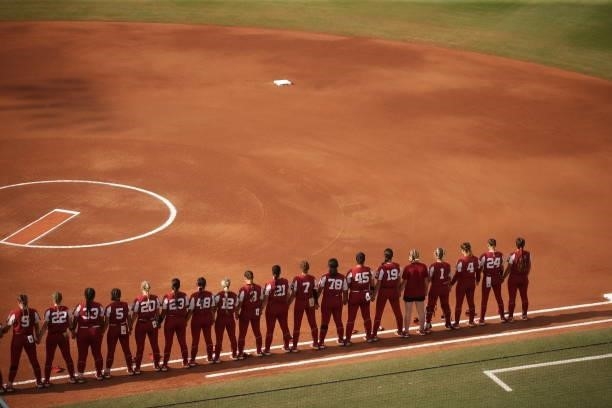 The Oklahoma Sooners stand along the first base line during the Division I Women's Softball Championship held at ASA Hall of Fame Stadium on June 9,...