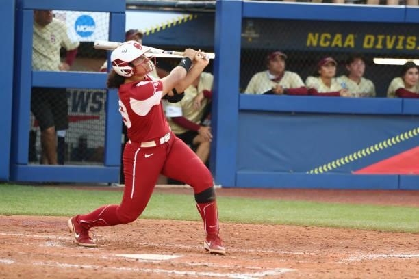 Jocelyn Alo of the Oklahoma Sooners hits a two-run home run against the Florida St. Seminoles during the Division I Women's Softball Championship...