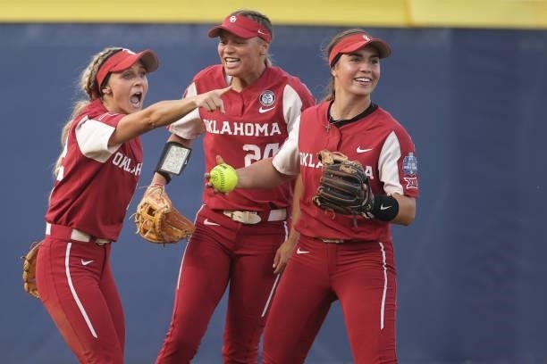 Mackenzie Donihoo of the Oklahoma Sooners celebrates with teammates after catching a fly ball during the Division I Women's Softball Championship...