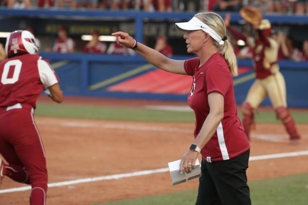 Head coach Patty Gasso of the Oklahoma Sooners directs her team from the third base line during the Division I Women's Softball Championship held at...