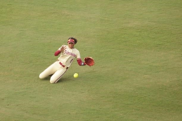 Kalei Harding of the Florida St. Seminoles makes a sliding catch in the outfield during the Division I Women's Softball Championship held at ASA Hall...