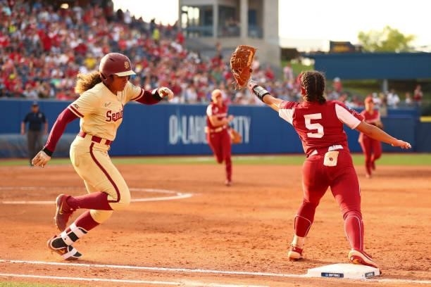 Elizabeth Mason of the Florida St. Seminoles is out at first by Taylon Snow of the Oklahoma Sooners during the Division I Women's Softball...