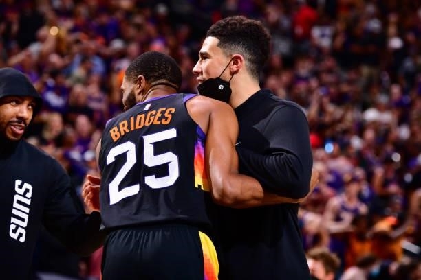 Devin Booker hugs Mikal Bridges of the Phoenix Suns during Round 2, Game 2 of the 2021 NBA Playoffs on June 9, 2021 at Phoenix Suns Arena in Phoenix,...