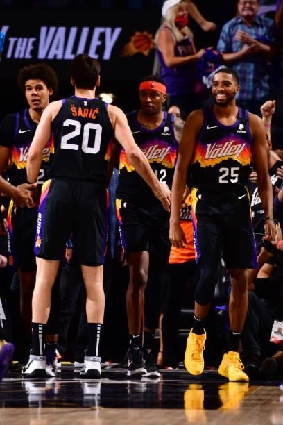 Mikal Bridges hi-fives Dario Saric of the Phoenix Suns during Round 2, Game 2 of the 2021 NBA Playoffs on June 9, 2021 at Phoenix Suns Arena in...