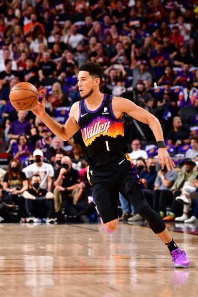 Devin Booker of the Phoenix Suns dribbles the ball during Round 2, Game 2 of the 2021 NBA Playoffs on June 9, 2021 at Phoenix Suns Arena in Phoenix,...