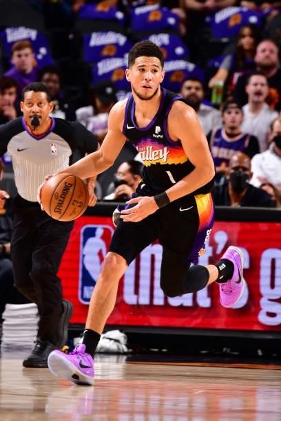 Devin Booker of the Phoenix Suns dribbles the ball during Round 2, Game 2 of the 2021 NBA Playoffs on June 9, 2021 at Phoenix Suns Arena in Phoenix,...