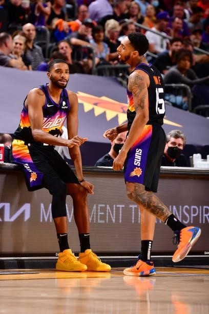 Mikal Bridges hi-fives Cameron Payne of the Phoenix Suns during Round 2, Game 2 of the 2021 NBA Playoffs on June 9, 2021 at Phoenix Suns Arena in...