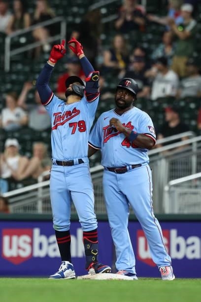 Gilberto Celestino celebrates hitting his first Major League hit for a single while Tommy Watkins of the Minnesota Twins looks on in the ninth inning...