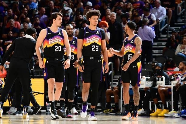 Cameron Johnson and Dario Saric of the Phoenix Suns look on during Round 2, Game 2 of the 2021 NBA Playoffs on June 9, 2021 at Phoenix Suns Arena in...
