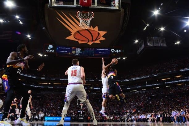 Chris Paul of the Phoenix Suns drives to the basket and looks to pass the ball against the Denver Nuggets during Round 2, Game 2 of the 2021 NBA...