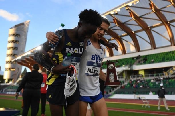 Conner Mantz of the BYU Cougars and Abdihamid Nur of the Northern Arizona University Lumberjacks embrace after finishing second and third in the...