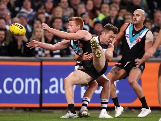 Willem Drew of the Power is tackled by Shaun Higgins of the Cats with Sam Powell-Pepper of the Power during the 2021 AFL Round 13 match between the...