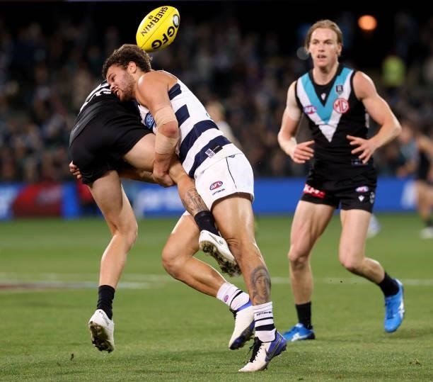 Kane Farrell of the Power is tackled by Brandan Parfitt of the Cats during the 2021 AFL Round 13 match between the Port Adelaide Power and the...