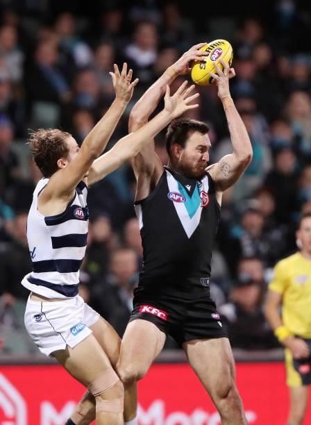 Charlie Dixon of the Power marks the ball from Jake Kolodjashnij of the Cats during the 2021 AFL Round 13 match between the Port Adelaide Power and...
