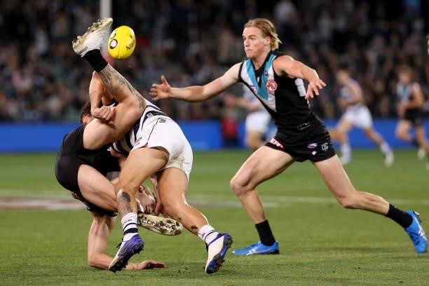 Kane Farrell of the Power is tackled by Brandan Parfitt of the Cats during the 2021 AFL Round 13 match between the Port Adelaide Power and the...