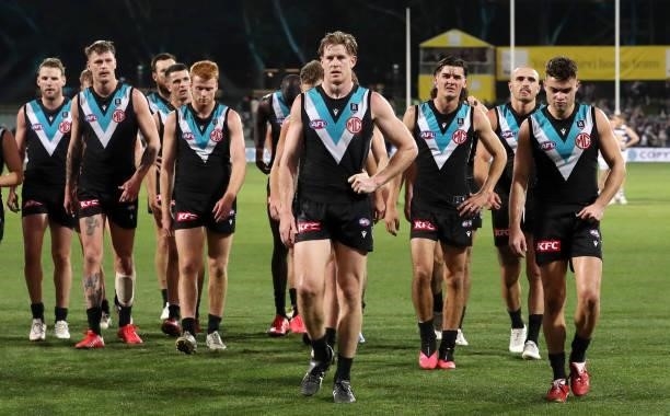 Tom Jonas of the Power leads his team off the oval after the loss during the 2021 AFL Round 13 match between the Port Adelaide Power and the Geelong...