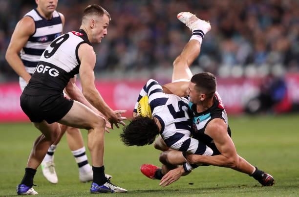Ryan Burton of the Power tackles Brad Close of the Cats during the 2021 AFL Round 13 match between the Port Adelaide Power and the Geelong Cats at...