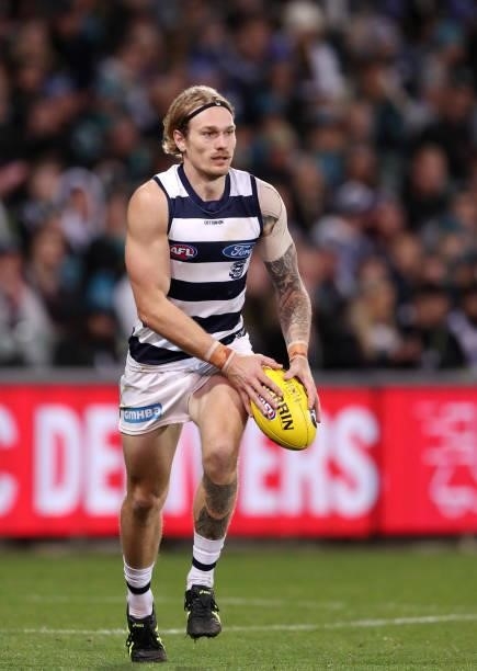 Tom Stewart of the Cats kicks the ball during the 2021 AFL Round 13 match between the Port Adelaide Power and the Geelong Cats at Adelaide Oval on...