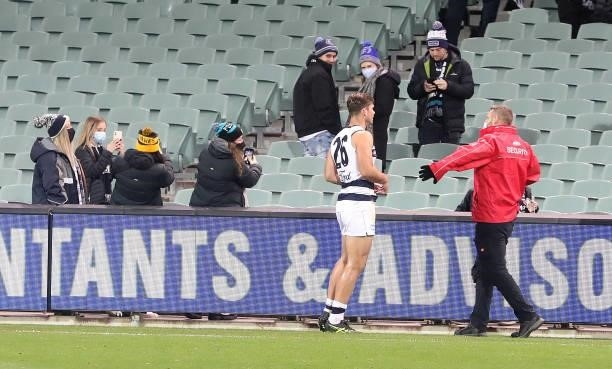 Security ask Tom Hawkins of the Cats to move away from fans after the game during the 2021 AFL Round 13 match between the Port Adelaide Power and the...