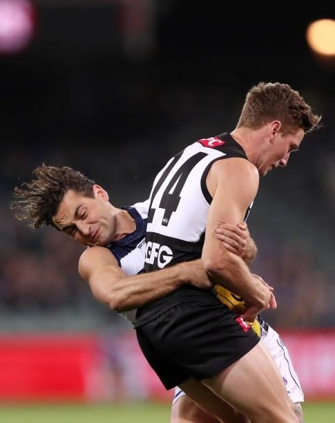 Luke Dahlhaus of the Cats tackles Kane Farrell of the Power during the 2021 AFL Round 13 match between the Port Adelaide Power and the Geelong Cats...