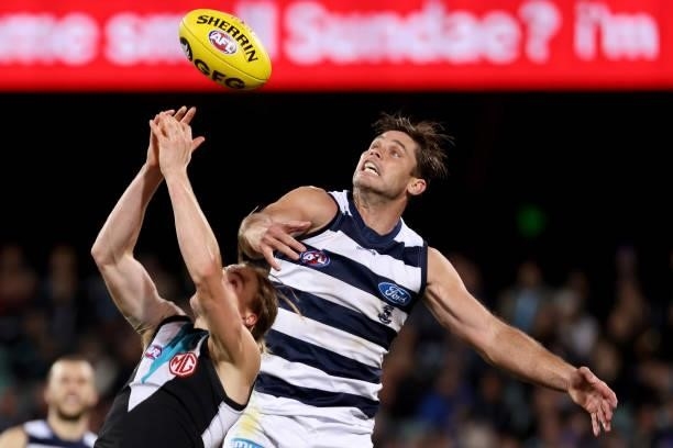 Miles Bergman of the Power competes with Tom Hawkins of the Cats during the 2021 AFL Round 13 match between the Port Adelaide Power and the Geelong...