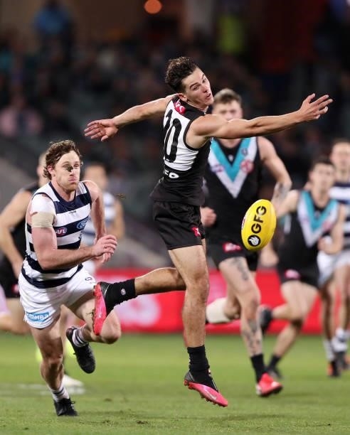 Connor Rozee of the Power and Jed Bews of the Cats during the 2021 AFL Round 13 match between the Port Adelaide Power and the Geelong Cats at...
