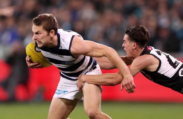 Tom Atkins of the Cats and Connor Rozee of the Power during the 2021 AFL Round 13 match between the Port Adelaide Power and the Geelong Cats at...