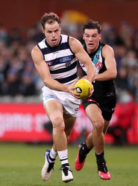 Jake Kolodjashnij of the Cats and Connor Rozee of the Power during the 2021 AFL Round 13 match between the Port Adelaide Power and the Geelong Cats...