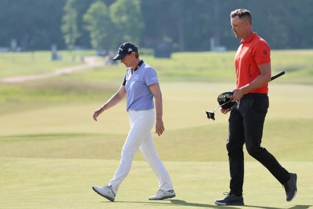Henrik Stenson of Sweden walks off the 18th green with Annika Sorenstam of Sweden during the first round of The Scandinavian Mixed Hosted by Henrik...