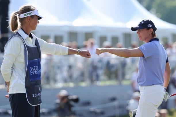 Annika Sorenstam of Sweden reacts to her caddie on the 18th green during the first round of The Scandinavian Mixed Hosted by Henrik and Annika at...