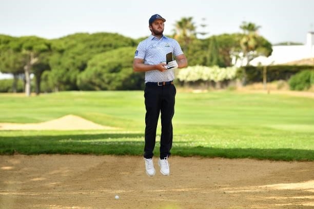 Damien Perrier of France jumps into the bunker to lines before plays his second shoot on the first hole during Day One of the Challenge de Cadiz at...